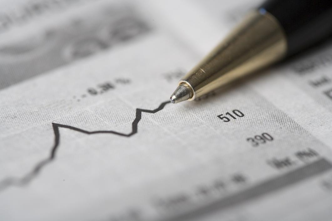 Chart of stock bonds growth with a black pen over the newspaper.